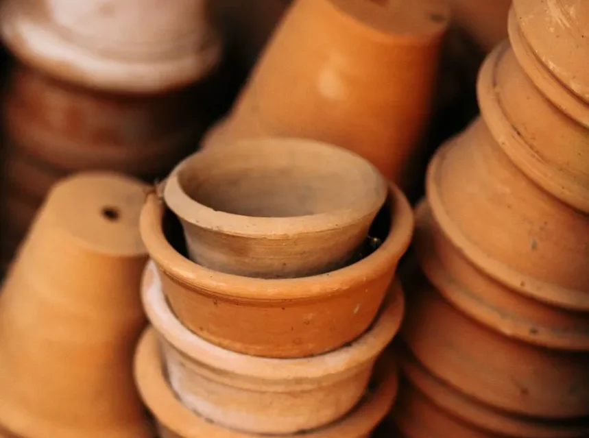 Best plant pot — stacks of weathered terracotta pots piled together in a potting shed
