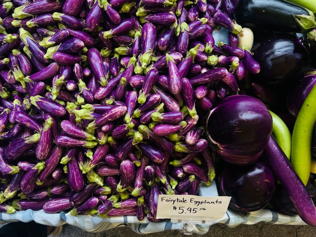 A vibrant display of fairytale eggplants for sale at a local market.