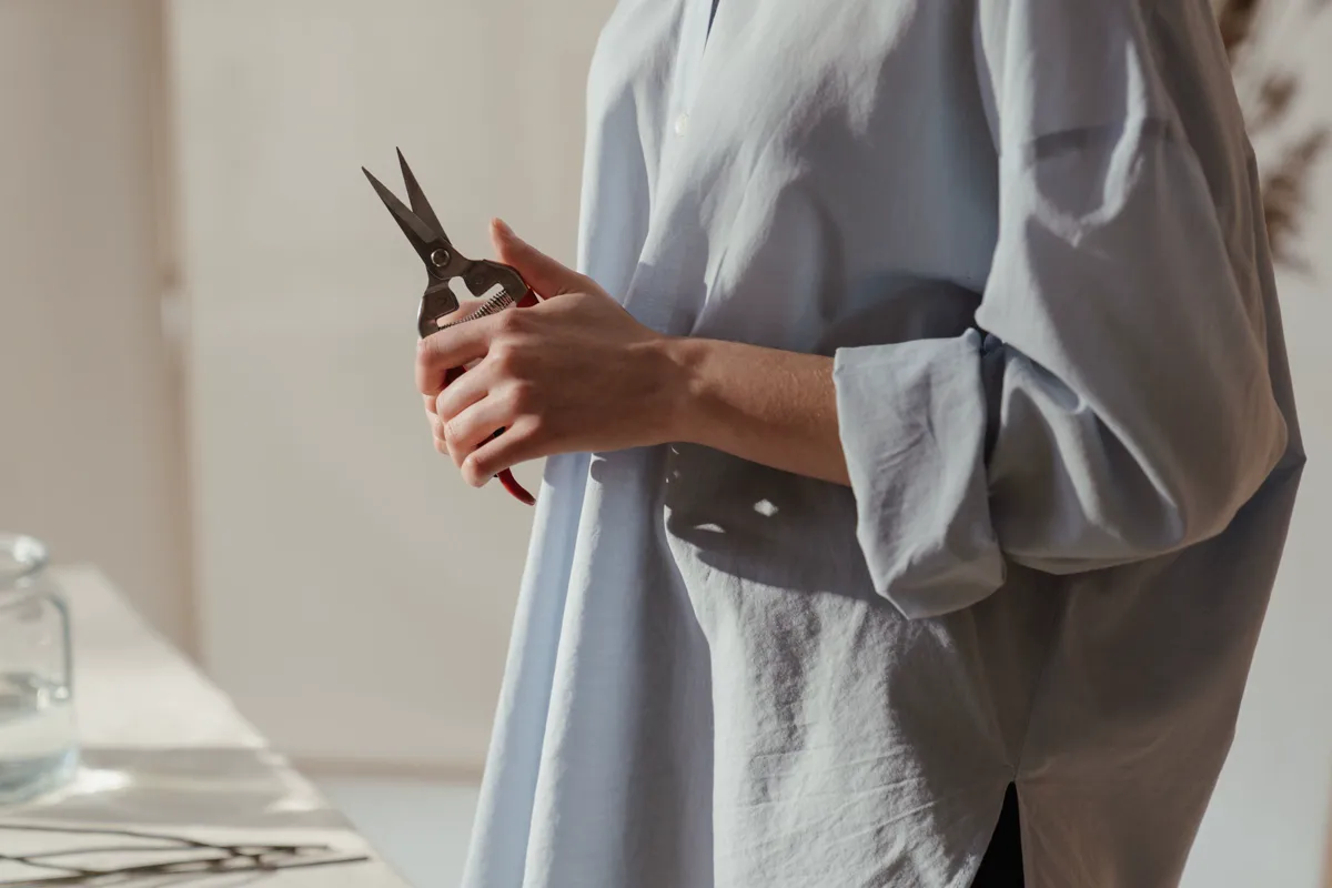 Christmas gifts for gardeners - a pair of narrow-bladed floral snips held in a bright room
